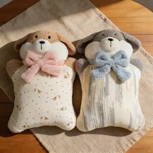 Close-up of two cute plush dog pillows with colorful bow ties on a cozy beige fabric surface