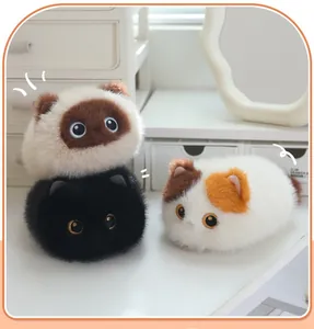 Detailed view of three fluffy cat plush toys in Siamese, black, and calico styles.