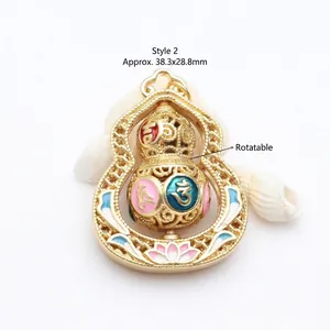 Detail of rotatable gold gourd pendant with colorful enamel mantra symbols.