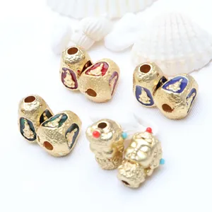 Detail view of gold-plated Thai Buddha beads with colorful enamel for DIY jewelry accessories