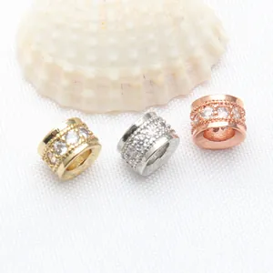 Close-up of micro-pave cubic zirconia spacer beads in gold, silver, and rose gold finishes.