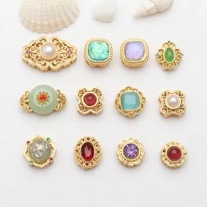 Detailed view of assorted hollow gold-plated beads with colorful gemstones for DIY jewelry.