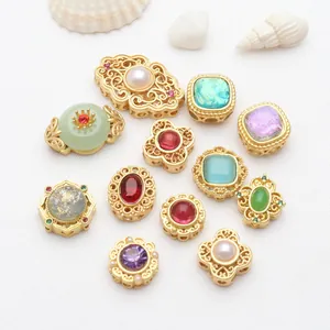 Detailed view of gold plated hollow spacer beads with inlaid gemstones for DIY jewelry