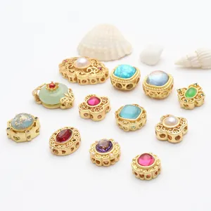 Detail view of gold-plated hollow jewelry beads with colorful gemstones for DIY crafts