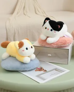 Cute calico and tuxedo cat plush toys displayed on a stylish desk setting