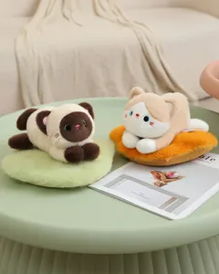 Two adorable cat plushies resting on colorful fuzzy mats in a cozy indoor setting.