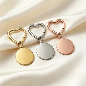 Detail view of heart-shaped stainless steel keychains with blank round tags for engraving