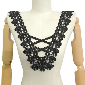 Detailed view of black hollow embroidered lace collar on a mannequin torso