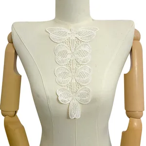Detailed macro view of white embroidered lace hollow flower applique for collar decoration