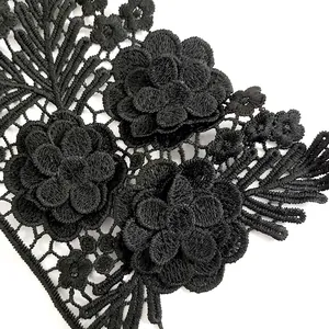 Detailed macro view of 3D black milk silk embroidered floral lace applique for collars