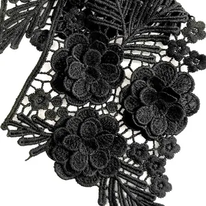 Macro detail of black floral embroidery lace collar with intricate 3D stitching