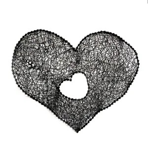 Detail shot of black heart embroidery lace patch with hollow center for DIY crafts