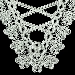 Detailed view of intricate white butterfly lace embroidery with cutout patterns