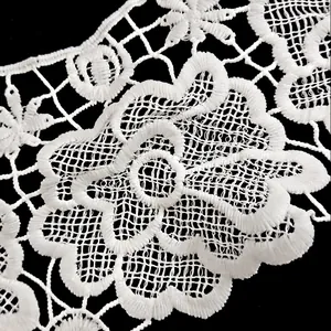 Detailed close-up of white milk silk hollow floral embroidery lace collar fabric.
