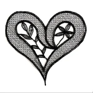 Close-up of black heart-shaped lace embroidery patch with intricate floral details.
