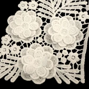 Detailed close-up of white 3D floral milk silk embroidered lace applique for clothing