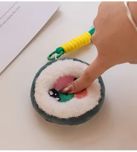 Detailed macro view showing the soft plush texture of a cartoon sushi roll charm