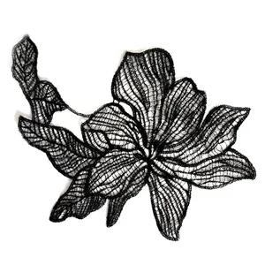 Detailed view of delicate black fish-line lace flower embroidery patch for DIY crafts.
