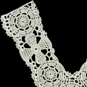 Macro detail of white polyester embroidered lace false collar with hollow floral patterns