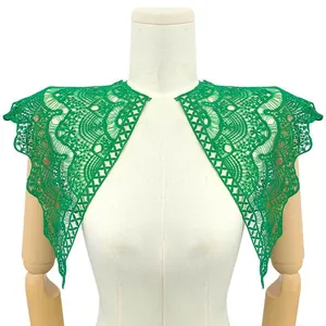 Detail view of green lace collar appliques with intricate floral embroidery on mannequin