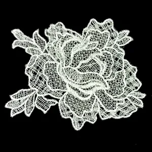 Detailed view of delicate white floral lace embroidery applique for DIY sewing project