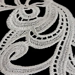Macro detail of white water-soluble lace embroidery applique for DIY sewing crafts