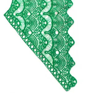 Detailed view of bright green milk silk embroidered lace with intricate floral hollow patterns