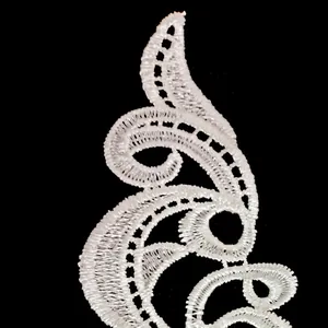Detailed macro view of white water-soluble embroidery lace patch with hollow out pattern