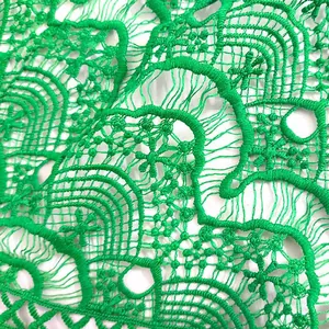 Detailed macro view showing the texture of vibrant emerald green milk silk embroidery lace