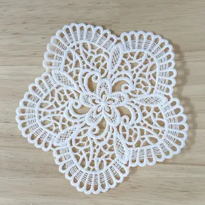 Detailed view of a white vintage water-soluble lace floral applique patch for DIY decor
