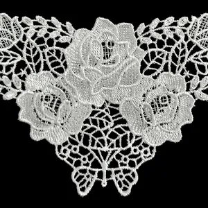 Close-up of white rose floral lace embroidery patch with intricate hollow out design