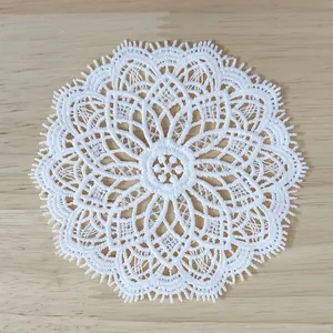 Detailed macro view of white vintage water-soluble lace floral embroidery patch for DIY decor