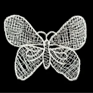 Detailed macro view of a white mesh lace butterfly embroidery patch for DIY crafts
