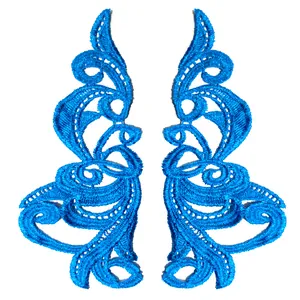 Close-up of bright blue water-soluble embroidery lace patches with symmetrical scroll design