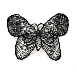 Detailed close-up of a delicate black lace butterfly patch with intricate mesh embroidery.