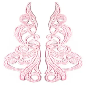 Detailed view of symmetrical pink water-soluble embroidered lace appliques for DIY sewing