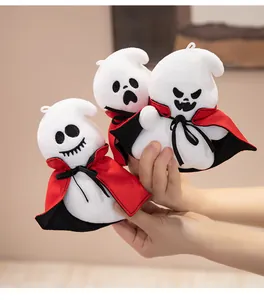 Detailed view of three cute Halloween ghost plush dolls in red capes being held.
