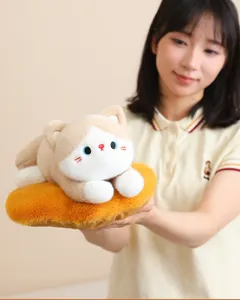 Close-up of a cute calico cat plush doll held by a model on a fluffy orange base