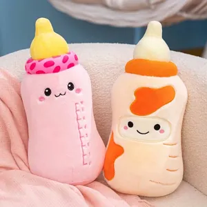 Pair of soft baby bottle plush pillows with cute kawaii faces and embroidered details