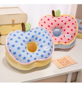 Detailed view of apple-shaped nap pillows with polka dots for office and school use