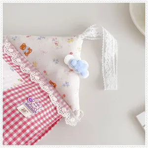 Close-up of a cute hanging tissue bag with lace edges and animal prints.
