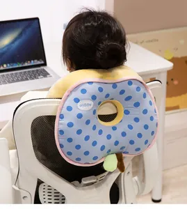 Detail view of blue polka dot apple-shaped nap pillow being used as a cozy chair backrest