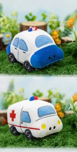 Detailed view of cute plush police car and ambulance toys on a green moss background