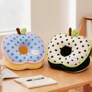 Pair of apple-shaped polka dot ice silk nap pillows on a desk for office or school