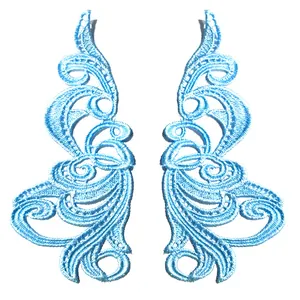 Detailed texture of symmetrical light blue water-soluble embroidery lace patches.