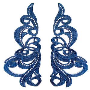 Detailed view of royal blue 3D hollow embroidered lace patches in a symmetrical pair