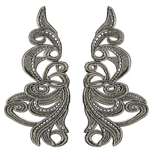 Detailed macro view of symmetrical golden baroque embroidery lace patches for DIY crafts