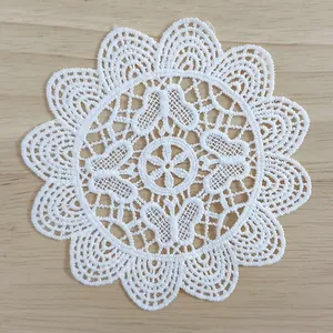 Detailed macro view of white water-soluble lace patch with butterfly embroidery patterns