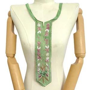Close-up of green lace collar with pink floral embroidery in a tie-shaped design