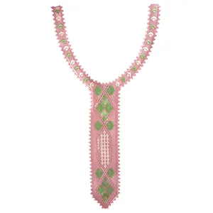 Detail of pink and green embroidered lace collar patch with geometric patterns.